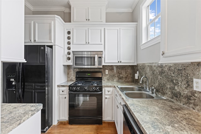 kitchen with white cabinetry, sink, crown molding, and black appliances