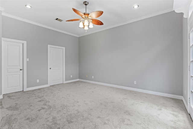 empty room featuring crown molding, ceiling fan, and carpet