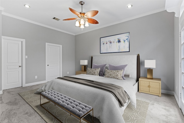 carpeted bedroom featuring ornamental molding and ceiling fan