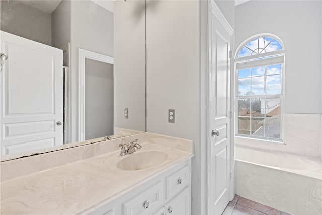 bathroom featuring vanity, a bath, and tile patterned floors