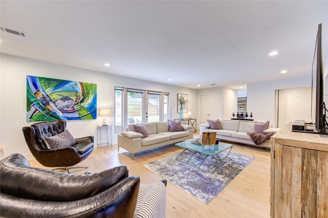 living room featuring french doors and light wood-type flooring