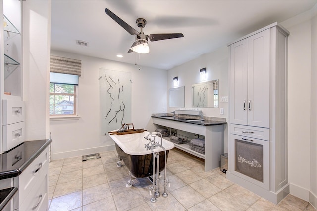 kitchen with ceiling fan, sink, and light tile patterned floors