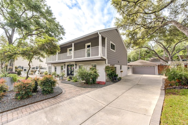 view of front of home with an outbuilding, a garage, and a balcony