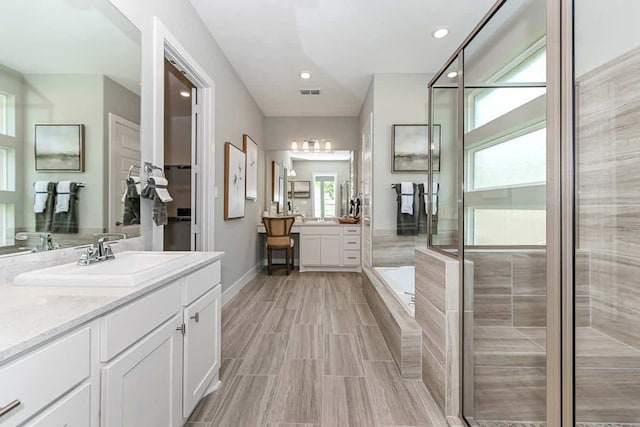 bathroom with vanity, an enclosed shower, and hardwood / wood-style floors