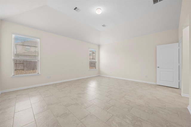 unfurnished room with vaulted ceiling