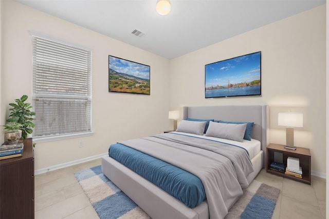 bedroom with light tile patterned floors