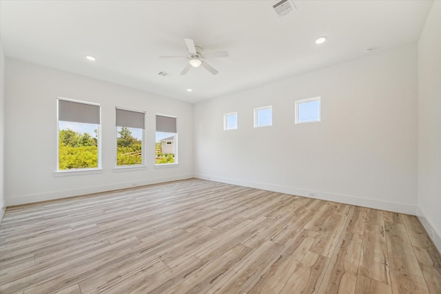 spare room with recessed lighting, visible vents, light wood-style flooring, and baseboards