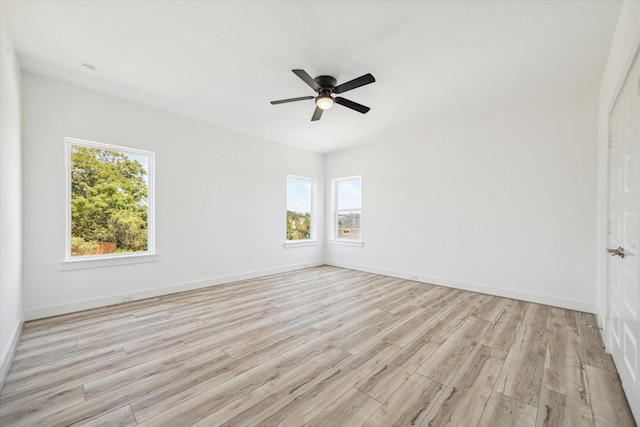 spare room featuring light hardwood / wood-style flooring and ceiling fan