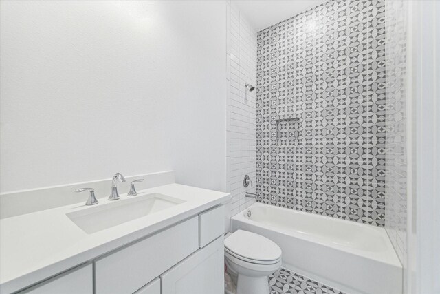 bathroom featuring toilet, vanity, and washtub / shower combination