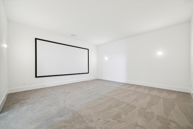 carpeted home theater room featuring baseboards and visible vents