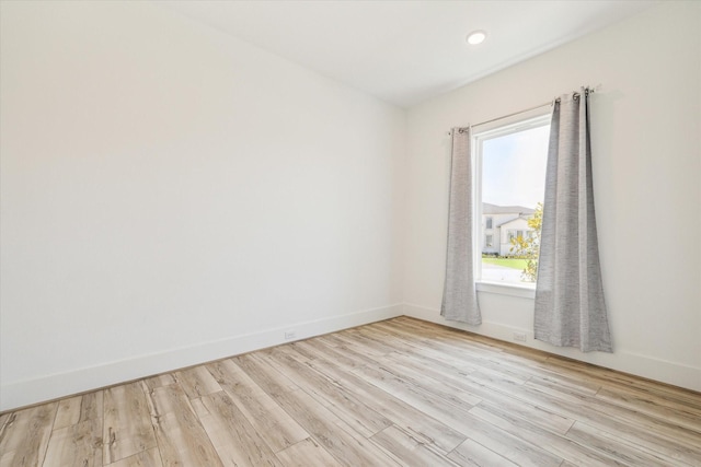 unfurnished room featuring light wood finished floors and baseboards