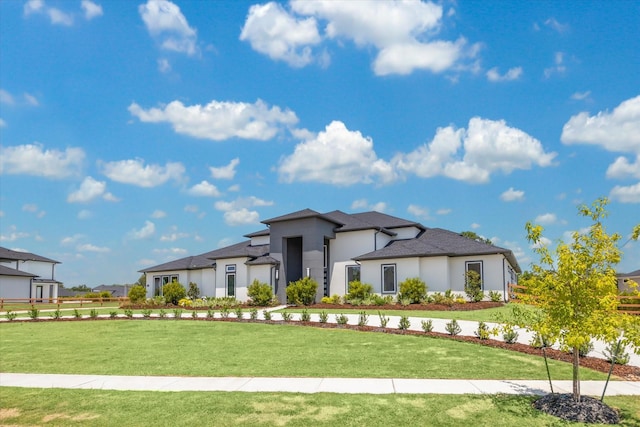 prairie-style home with stucco siding and a front yard