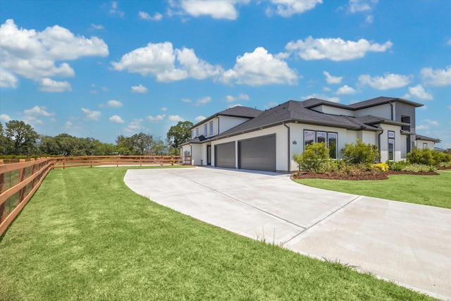 view of side of home with stucco siding, driveway, fence, a yard, and a garage