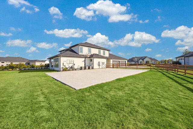 rear view of property with a yard and volleyball court