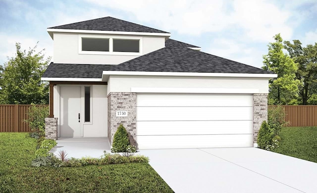 view of front of house featuring a garage and a front yard