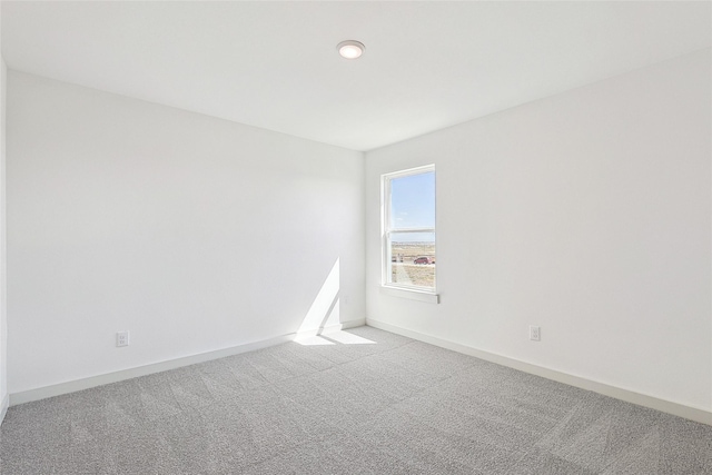 unfurnished room with light carpet