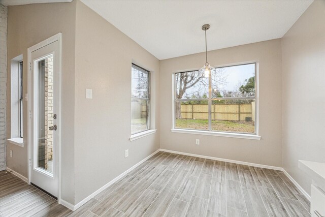 unfurnished dining area featuring light hardwood / wood-style floors