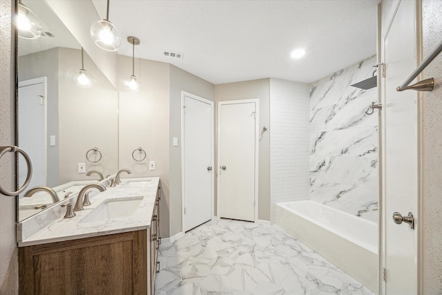 bathroom with vanity and tiled shower / bath combo