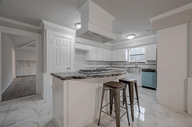 kitchen featuring sink, white cabinetry, dark stone countertops, a kitchen breakfast bar, and stainless steel appliances