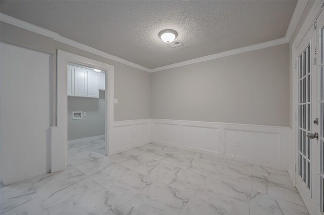 spare room featuring crown molding and a textured ceiling