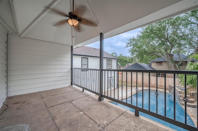 view of patio featuring a fenced in pool and ceiling fan