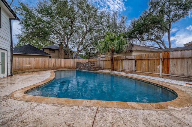 view of swimming pool featuring pool water feature and a patio area