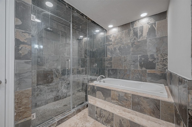 bathroom featuring tile walls and independent shower and bath