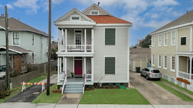 1209 Rosenberg St, Galveston, TX 77550 - view of front of property with a porch, a balcony, and asphalt driveway