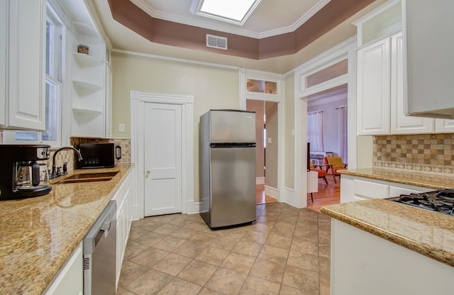 1209 Rosenberg St, Galveston, TX 77550 - kitchen with appliances with stainless steel finishes, open shelves, a sink, tasteful backsplash, and crown molding