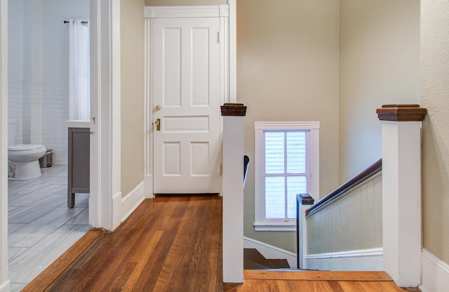 interior space with tile walls and wood-type flooring