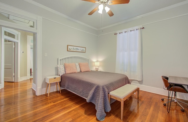 bedroom with hardwood / wood-style flooring, ornamental molding, and ceiling fan