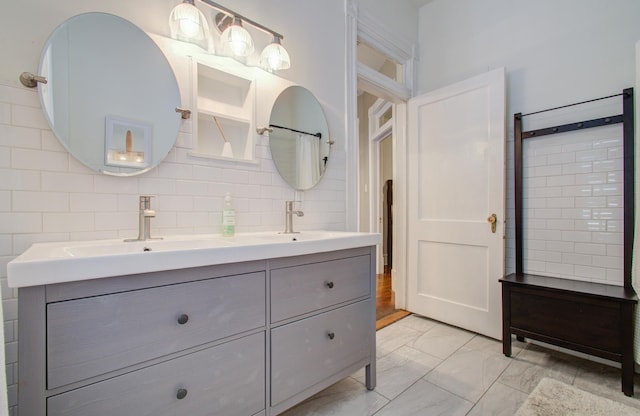 bathroom featuring vanity and decorative backsplash