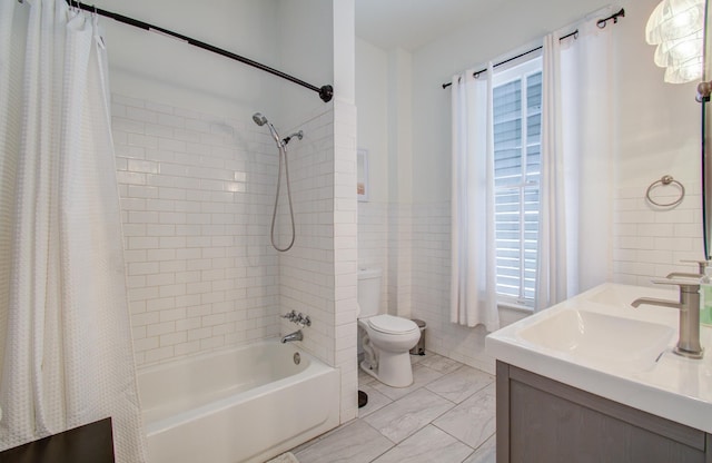 full bathroom featuring vanity, toilet, tile walls, and shower / bath combo