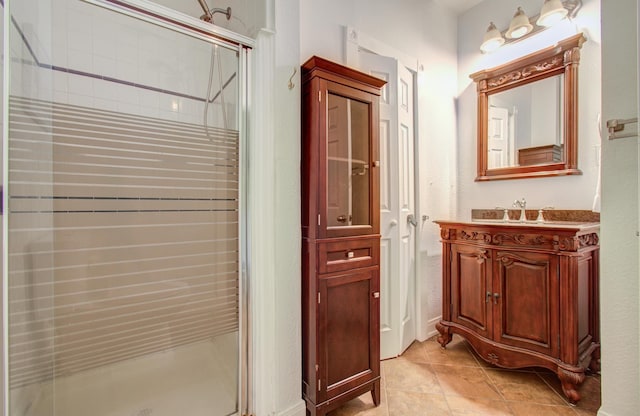 bathroom with tile patterned flooring, vanity, and an enclosed shower