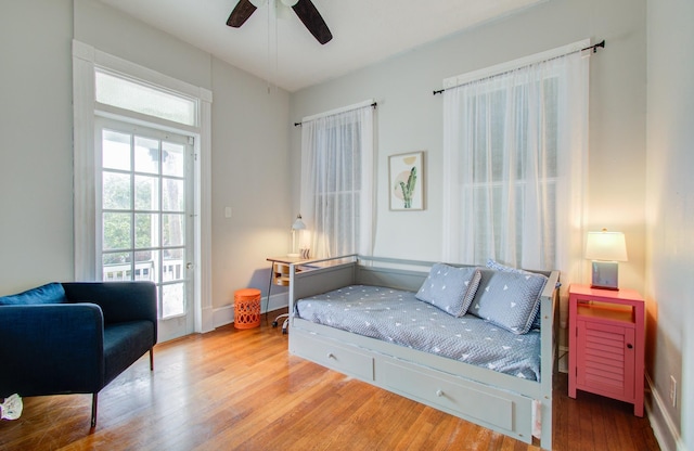 bedroom with hardwood / wood-style floors and ceiling fan