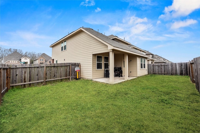 back of property featuring a patio and a lawn