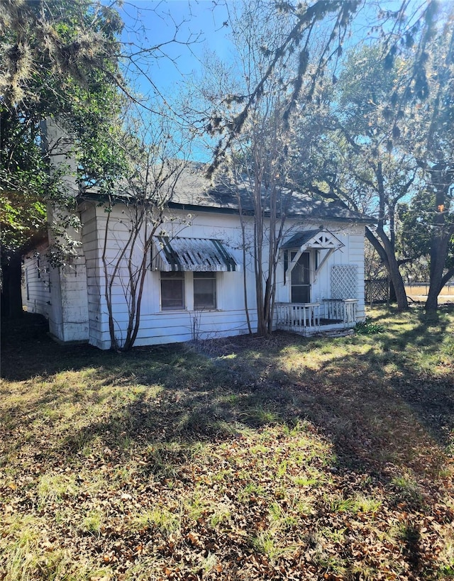 back of property with a lawn