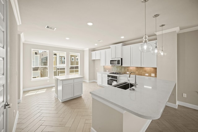 5613 Iris Harvest Ln, Houston, TX 77091 - kitchen with a sink, appliances with stainless steel finishes, crown molding, baseboards, and decorative backsplash