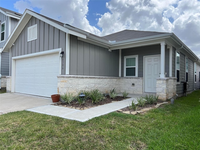 view of front of property with a garage and a front lawn