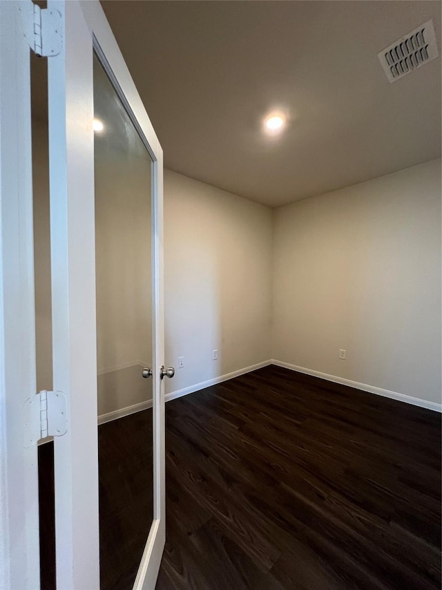 empty room featuring dark wood-type flooring