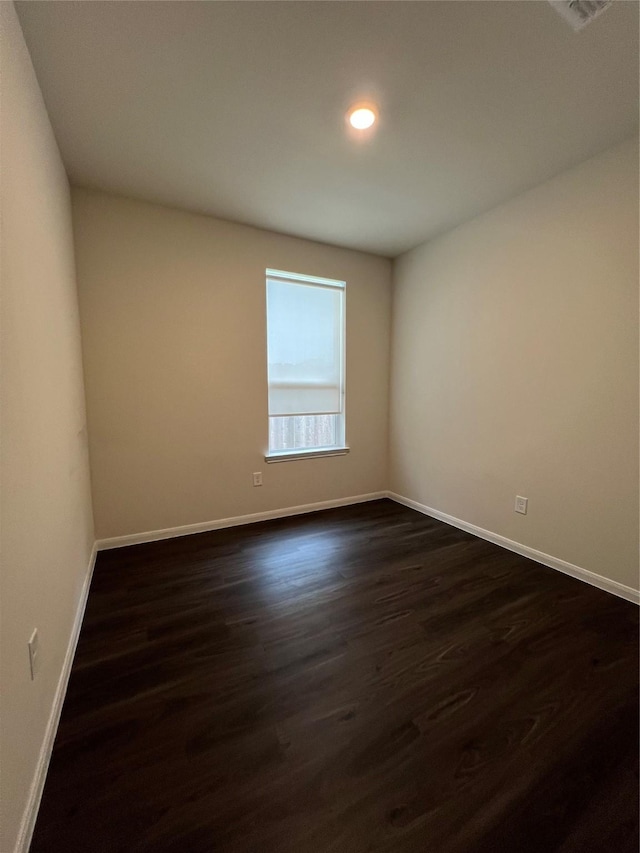 empty room featuring dark wood-type flooring