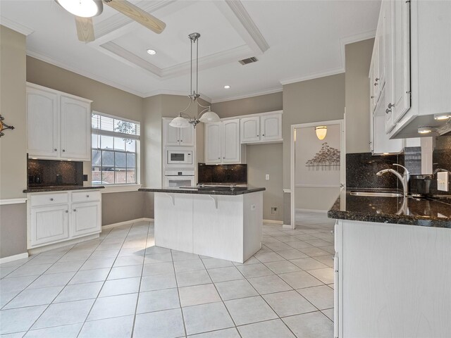 kitchen featuring crown molding, hanging light fixtures, light tile patterned floors, white appliances, and white cabinets