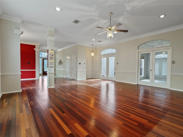 unfurnished living room with crown molding, dark wood-type flooring, decorative columns, and french doors