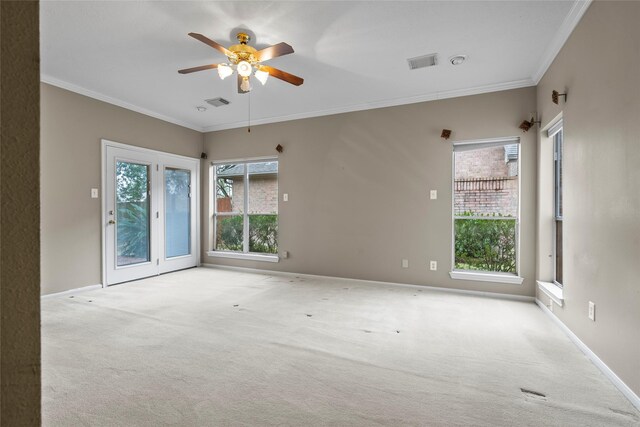 spare room with ornamental molding, light colored carpet, and ceiling fan