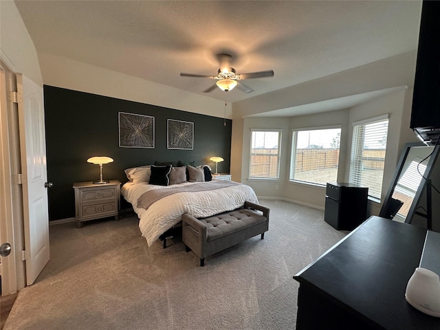 carpeted bedroom with a ceiling fan and baseboards