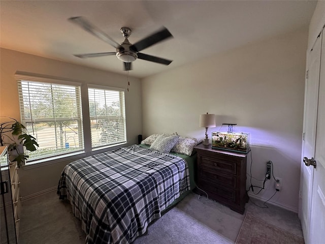 carpeted bedroom featuring ceiling fan and baseboards