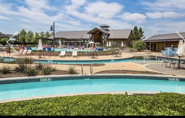 pool with a patio area and fence