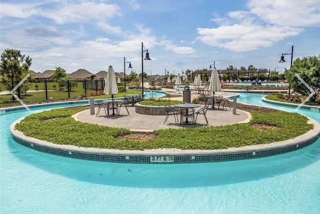 surrounding community featuring a pool and a patio area