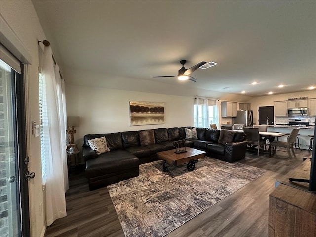 living area featuring a ceiling fan, dark wood finished floors, visible vents, and recessed lighting