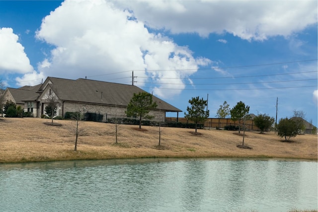 property view of water featuring fence